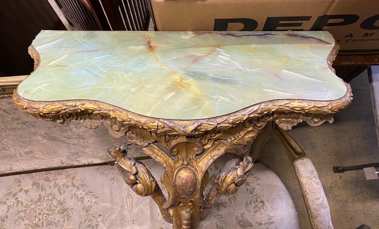 A Victorian giltwood and composition console table, with later faux onyx top, width 62cms, depth 32cms, height 86cms. Please note that the gilt moulding has been damaged.